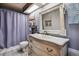 Charming bathroom featuring a vintage vanity, skylight, ornate mirror, and a shower with curtain at 1744 Brookside Dr, Highlands Ranch, CO 80126