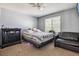 Cozy bedroom with a comfortable bed, dresser, and ample natural light from the window at 1744 Brookside Dr, Highlands Ranch, CO 80126