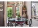 Cozy dining area with a glass-top table and elegant chandelier, adjacent to a large window at 1744 Brookside Dr, Highlands Ranch, CO 80126
