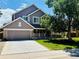 Charming two-story home with a well-maintained front yard and a two car attached garage at 1744 Brookside Dr, Highlands Ranch, CO 80126