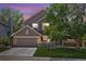 Charming two-story home with stone accents, a well-manicured lawn, and an attached two-car garage at 1744 Brookside Dr, Highlands Ranch, CO 80126
