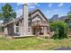 Two-story home with a balcony overlooking a manicured lawn and outdoor patio area at 1744 Brookside Dr, Highlands Ranch, CO 80126