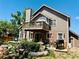 Beautiful home exterior featuring a spacious deck, outdoor furniture, a barbecue grill, and lush landscaping at 1744 Brookside Dr, Highlands Ranch, CO 80126