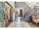 Bright foyer with tile flooring and an open staircase at 1744 Brookside Dr, Highlands Ranch, CO 80126