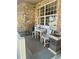 Inviting front porch with seating, a stone wall fountain and decor at 1744 Brookside Dr, Highlands Ranch, CO 80126