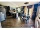 Open concept kitchen with wood floors, an island, and a charming eat in dining space at 1744 Brookside Dr, Highlands Ranch, CO 80126