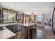Well-equipped kitchen featuring an island with bar stools, stainless steel appliances and modern lighting at 1744 Brookside Dr, Highlands Ranch, CO 80126