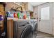 Well-equipped laundry room featuring modern washer/dryer and storage, providing functionality and convenience at 1744 Brookside Dr, Highlands Ranch, CO 80126