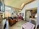 Open-concept living room with plenty of natural light, fireplace, and staircase at 1744 Brookside Dr, Highlands Ranch, CO 80126