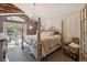 Elegant bedroom with a four-poster bed, chandelier, decorative accents, and french doors at 1744 Brookside Dr, Highlands Ranch, CO 80126