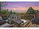 Relaxing outdoor deck with seating, table and workout equipment overlooking scenic neighborhood views at 1744 Brookside Dr, Highlands Ranch, CO 80126
