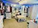 Spacious walk-in closet with ample shelving, storage, carpet, lighting, mirror, and center island at 1744 Brookside Dr, Highlands Ranch, CO 80126