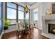 Bright dining area featuring a modern table set, fireplace, and expansive windows with city views at 5455 Landmark Pl # 815, Greenwood Village, CO 80111