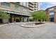 Elegant entrance with circular driveway, fountain, and manicured landscaping at 5455 Landmark Pl # 815, Greenwood Village, CO 80111