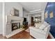 Inviting living room showcasing a fireplace, comfortable seating, and an open layout to the kitchen at 5455 Landmark Pl # 815, Greenwood Village, CO 80111