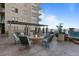 Inviting outdoor patio featuring a stone fireplace and elegant seating at 5455 Landmark Pl # 815, Greenwood Village, CO 80111