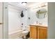 A well-lit bathroom has a tub-shower combo and light wood vanity cabinet at 8555 S Fairmount Dr # 107, Denver, CO 80247