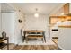 Dining area with wood table and bench with easy access to the kitchen at 8555 S Fairmount Dr # 107, Denver, CO 80247