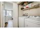 Convenient laundry area near the bedroom with a washer and dryer at 8555 S Fairmount Dr # 107, Denver, CO 80247