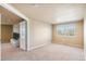 Expansive bedroom with neutral carpet, generous natural light, and a view into another room at 19602 E 63Rd Dr, Aurora, CO 80019