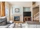 Living room featuring a fireplace, and carpet with hardwood flooring at 19602 E 63Rd Dr, Aurora, CO 80019