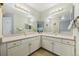 Well-lit bathroom featuring a double vanity, large mirrors, and neutral decor at 2164 S Troy Way, Aurora, CO 80014