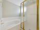 Clean bathroom featuring a separate tub with glass shower and tile surround at 2164 S Troy Way, Aurora, CO 80014
