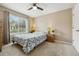 Comfortable bedroom featuring a ceiling fan and a large window for natural light at 2164 S Troy Way, Aurora, CO 80014