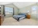 Spacious bedroom features bright light, a ceiling fan, and neutral decor at 2164 S Troy Way, Aurora, CO 80014