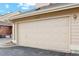 Two car garage with ample space for vehicles and storage with address numbers above at 2164 S Troy Way, Aurora, CO 80014
