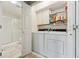 Efficient laundry room with washer, dryer, storage cabinets, and a convenient shower at 2164 S Troy Way, Aurora, CO 80014