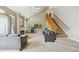 Bright living room with vaulted ceilings, fireplace, and staircase, perfect for relaxation at 2164 S Troy Way, Aurora, CO 80014