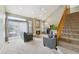 Spacious living room with fireplace, staircase, and sliding doors to the outdoor area at 2164 S Troy Way, Aurora, CO 80014
