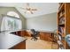 Bright office features custom built-in desk and cabinets, vaulted ceiling, and sun-filled window at 2164 S Troy Way, Aurora, CO 80014