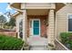 Inviting front porch with colorful door, brick accents, and charming decor at 2164 S Troy Way, Aurora, CO 80014