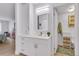 Bright bathroom features white cabinetry, a square mirror, a modern light fixture, and stylish fixtures at 13631 E Marina Dr # 105, Aurora, CO 80014