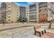 Attractive apartment building exterior with well-maintained landscaping and bench seating near the entrance at 13631 E Marina Dr # 105, Aurora, CO 80014