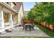 Well-maintained patio area with a table set, seamlessly blending with the surrounding green lawn at 9134 E 29Th Pl, Denver, CO 80238