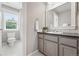 The bathroom features a vanity with countertop, mirror, toilet, and a shower, designed for comfort at 9134 E 29Th Pl, Denver, CO 80238