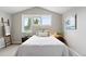 Bedroom with bright windows, a comfortable bed with decorative pillows, and a stylish side table at 9134 E 29Th Pl, Denver, CO 80238