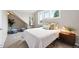 A cozy bedroom features a comfortable bed, soft carpet, bright windows, and tasteful decor at 9134 E 29Th Pl, Denver, CO 80238