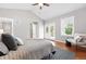 Bright bedroom with vaulted ceilings, natural light from french doors, and hardwood floors at 9134 E 29Th Pl, Denver, CO 80238