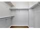 Walk-in closet with wood floor, shelving, and hanging rods, ready for organizing clothes and accessories at 9134 E 29Th Pl, Denver, CO 80238