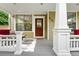 Inviting covered front porch with seating, perfect for enjoying the outdoors at 9134 E 29Th Pl, Denver, CO 80238