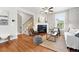 Spacious living room with fireplace, hardwood floors, and an open staircase at 9134 E 29Th Pl, Denver, CO 80238