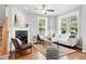 Comfortable living room features a fireplace, hardwood floors, and ample natural light at 9134 E 29Th Pl, Denver, CO 80238
