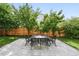 Beautiful backyard patio with outdoor table and chairs, surrounded by mature trees at 9134 E 29Th Pl, Denver, CO 80238