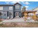 Blue two-story home with brick patio and wood pergola perfect for outdoor living and entertaining at 510 W Prestwick Way, Castle Rock, CO 80104