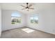 Spacious bedroom featuring a vaulted ceiling, two large windows, and soft neutral carpet at 510 W Prestwick Way, Castle Rock, CO 80104