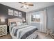 Cozy bedroom featuring a striped bedspread, modern ceiling fan, and natural light from the window at 510 W Prestwick Way, Castle Rock, CO 80104